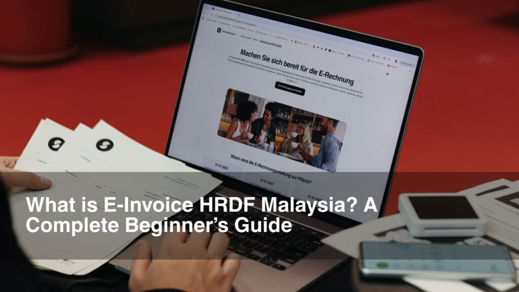 man on red table filling out einvoice on laptop